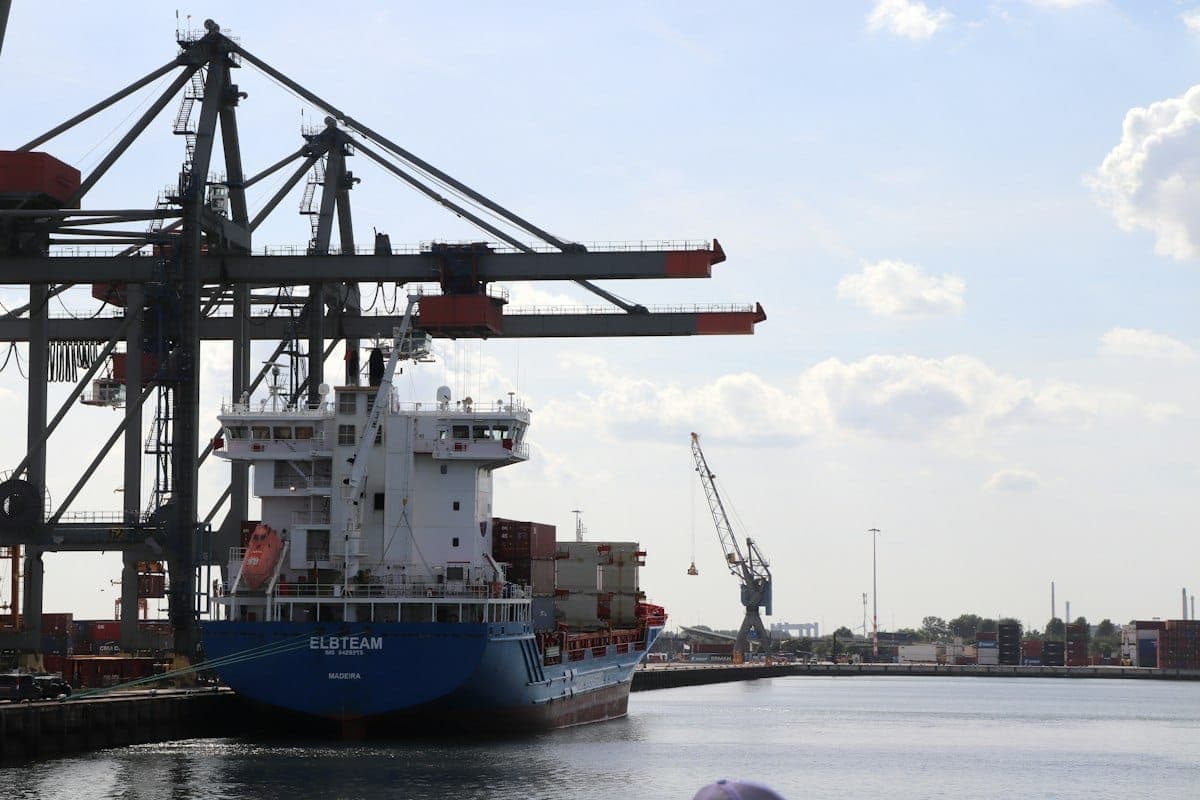 A container ship under port cranes